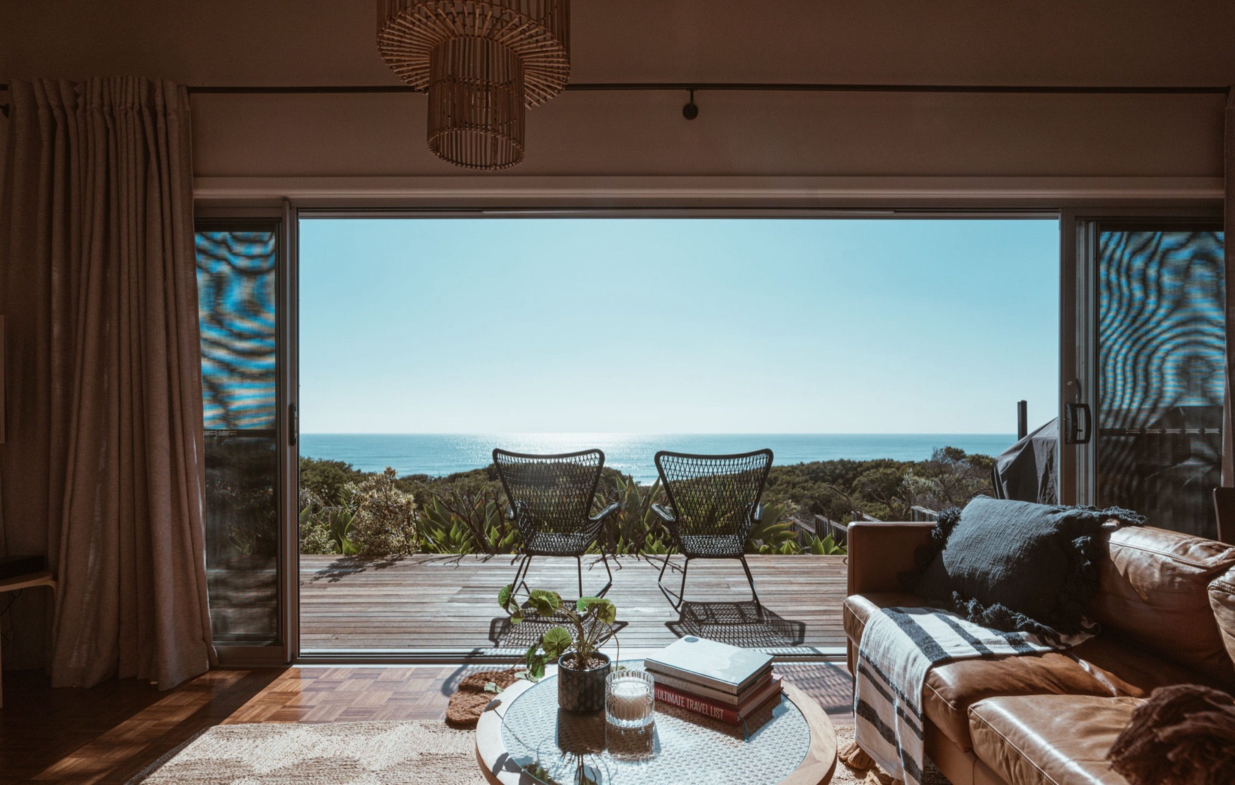 A bright living room opening onto an ocean view